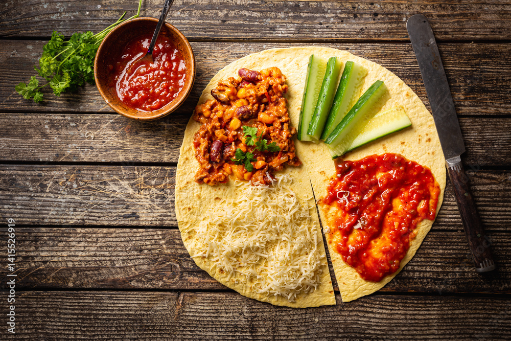 Tortilla wraps sandwiches with fresh vegetables, minced meat and on wooden background. Burrito, sandwich wrap, fajita wrap