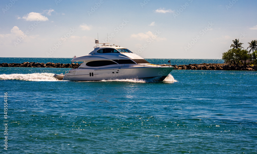 Yacht sailing on sea waters. Luxury superyacht at sea. Miami Beach with yachts. Seascape with a sailboat. Cruise ship near the coastline. Sunset yacht voyage. Luxury sailboat yacht. Boating.