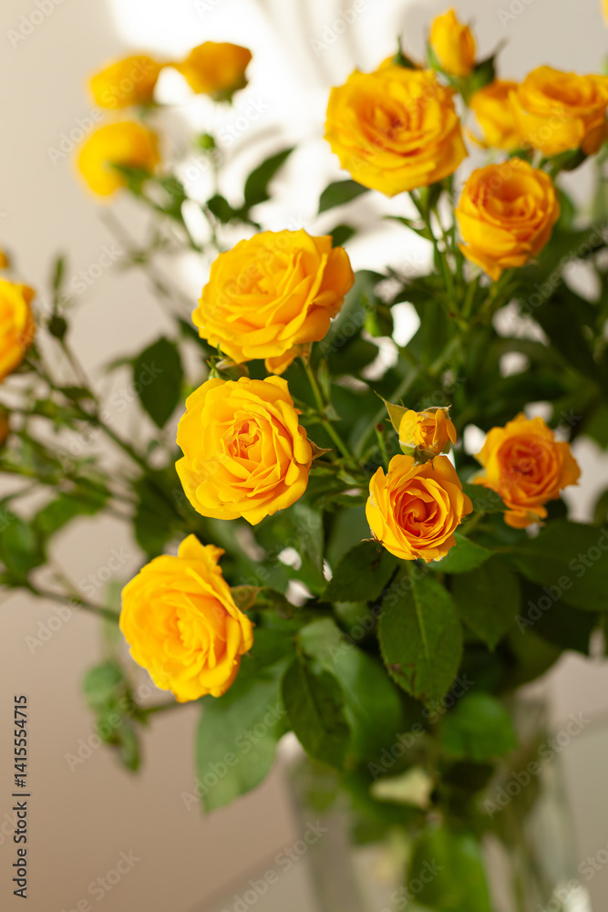 Bouquet of yellow roses in a glass vase. Flowers for the holiday. Decorations and ideas for home, parties and celebrations. Selective focus