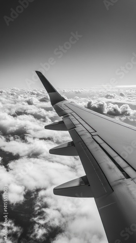 The aircraft wing extending over a beautiful white cloud formation