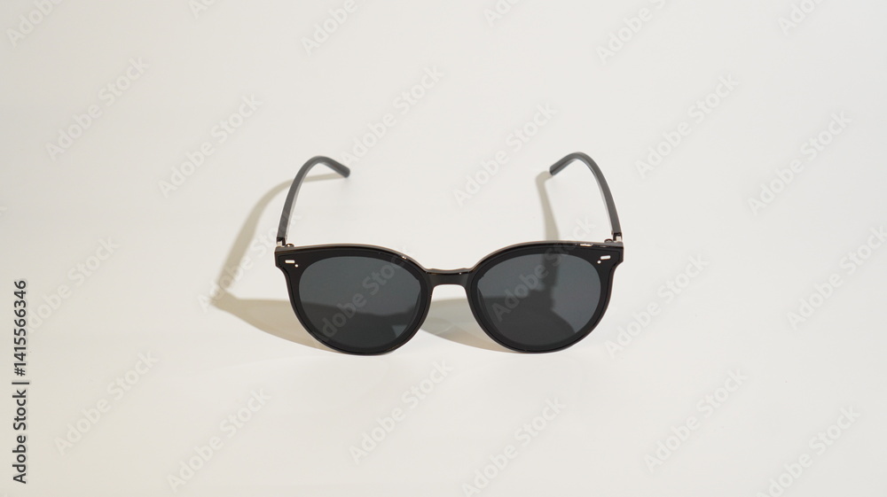 Modern sunglasses in black frame on plain background for eye protection Modern sunglasses in black frame on plain background for eye protection