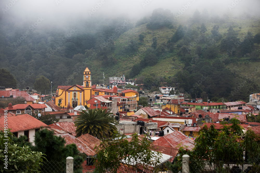 Foggy morning view of the historic church and cityscape of the pueblo of Pinal de Amoles, Querétaro, Mexico.