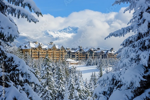 The view of the town and ski slopes in Whistler, with snow on them, snow-covered trees and mountains