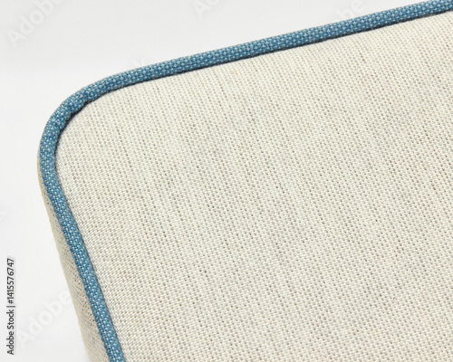 Obraz na płótnie Beige linen upholstery with blue piping creates a textured surface w salonie