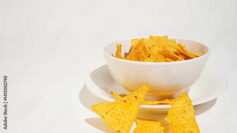 Crispy tortilla chips presentation in a bowl on a bright surface studio shot Crispy tortilla chips presentation in a bowl on a bright surface studio shot