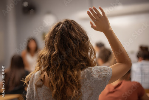 A smart young girl raising her hand in the classroom  photo