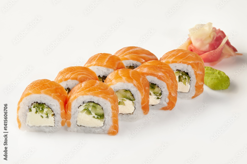 Philadelphia uramaki sushi rolls with salmon, cream cheese, cucumber, wasabi and ginger on white background