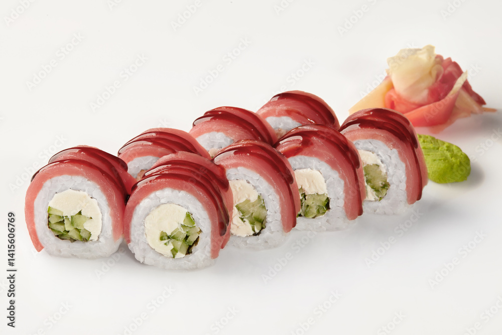 Delicious tuna uramaki sushi rolls with cucumber and cream cheese, drizzled with unagi sauce
