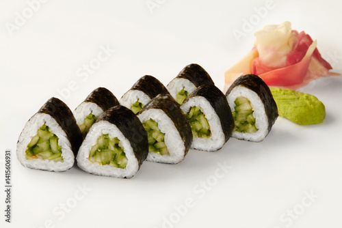 Obraz na płótnie Kappa maki sushi rolls with cucumber filling, pickled ginger, and wasabi on white background w salonie
