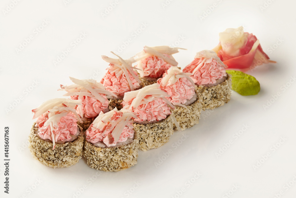 Delicious sushi rolls with cream cheese topping and sesame seeds on white background