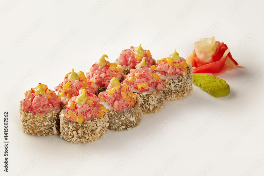 Tempura sushi rolls with spicy tuna, mango, and tobiko, featuring wasabi and ginger