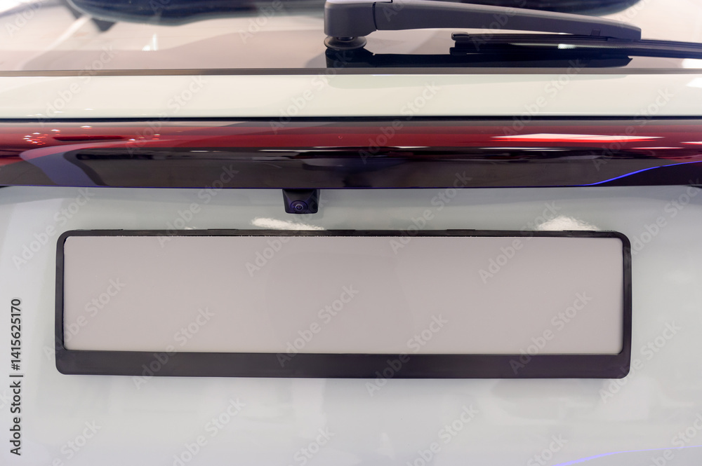 Close-up view of a car's license plate holder with a white background. Close-up view of a car's license plate holder with a white background.