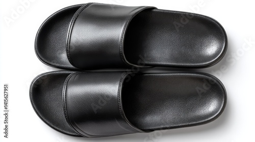 A pair of black slip-on slippers sandals, side view isolated on white background. Basic open-toe design, perfect for mock-up logos and casual footwear