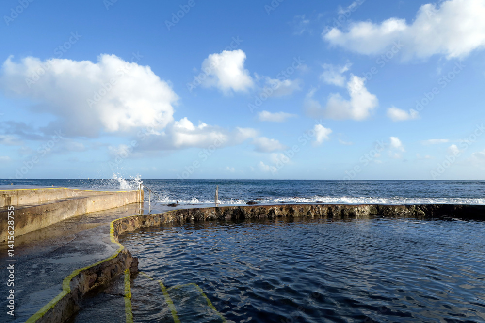 Salgueiros Bathing Area is one of the bays that has calmer and cleaner waters, where the Ribeira Seca flows. Praia da Vitória, Terceira Island, Azores, Portugal. Salgueiros Bathing Area is one of the bays that has calmer and cleaner waters, where the Ribeira Seca flows. Praia da Vitória, Terceira Island, Azores, Portugal.