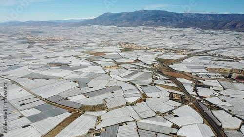 Aerial view of Mar de Plastico, Sea of ​​Plastic, in Almería. A vast expanse of land covered with plastic greenhouses for the production of fruits and vegetables, larger than Almería itself
