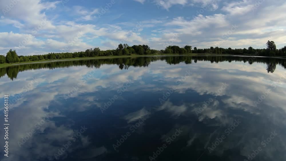 Reflection of clouds and nature at serene lake on a peaceful afternoon Reflection of clouds and nature at serene lake on a peaceful afternoon