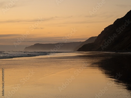 Relaxing orange pastel sky sunset nature landscape beach scene, Hamiltons Gap Awhitu Peninsula Auckland Region West Coast of North Island New Zealand photo