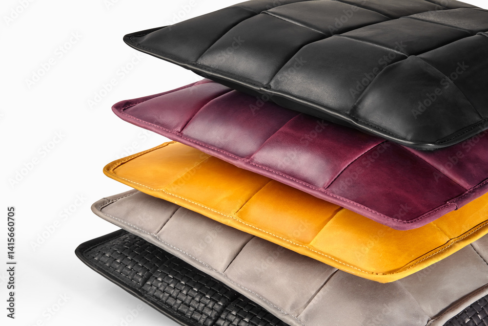 Stack of colorful leather pillows creating a cozy atmosphere