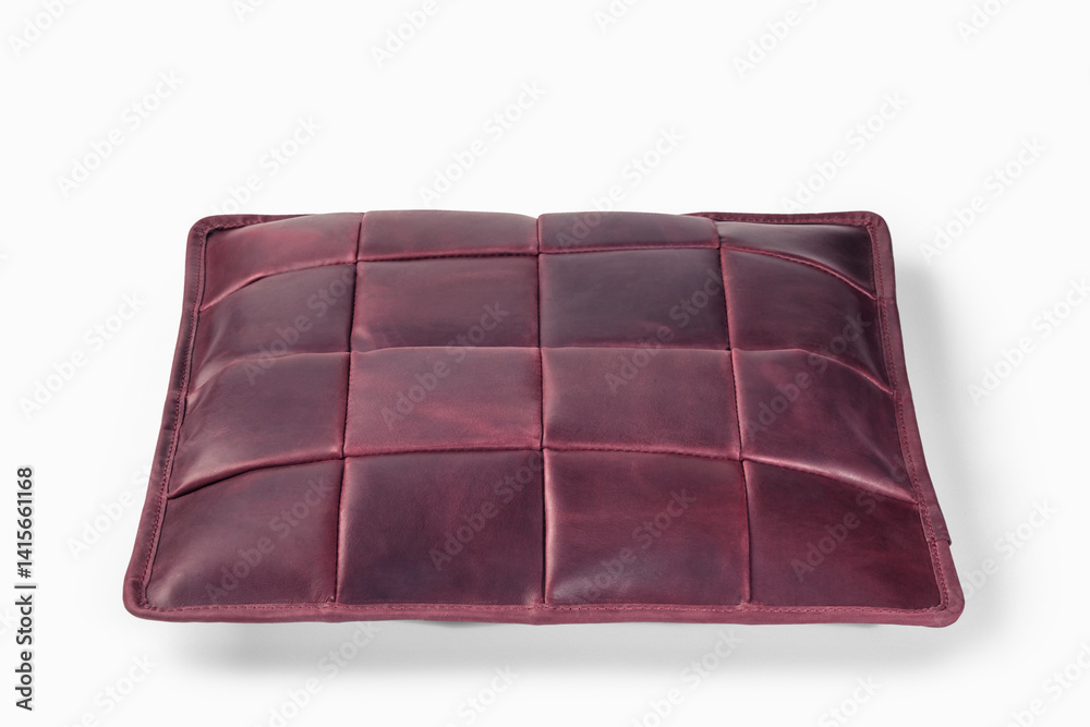Burgundy leather cushion floating on white background: modern home decor