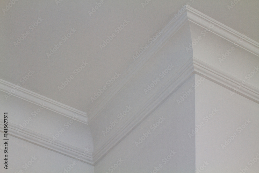 Fototapeta premium A white ceiling corner with decorative crown molding