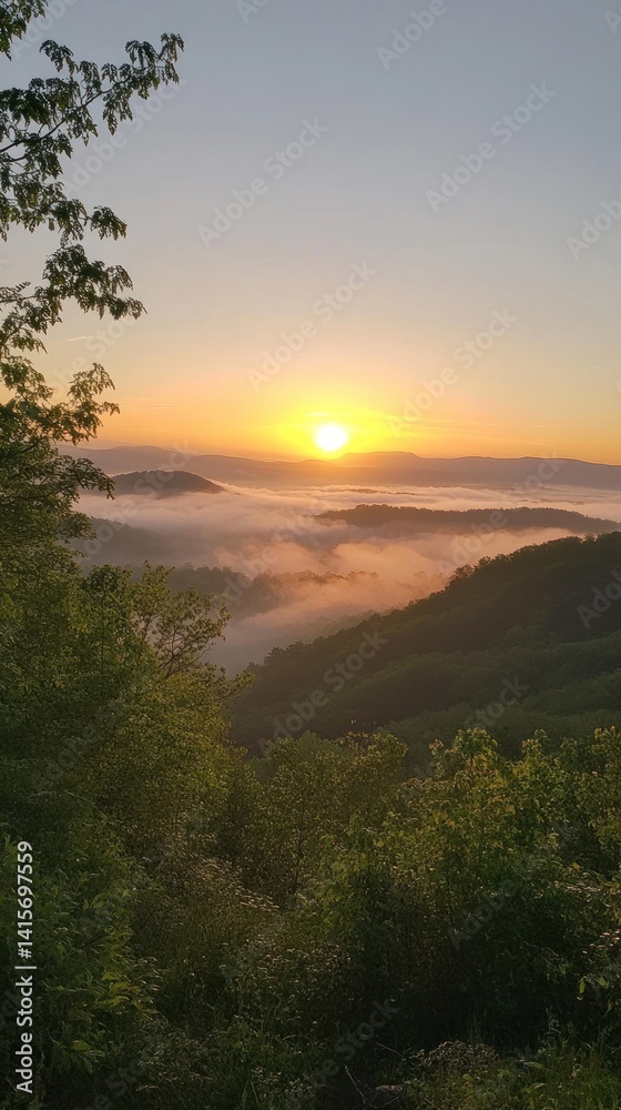 Naklejka premium A beautiful sunrise casts a warm light over distant mountains