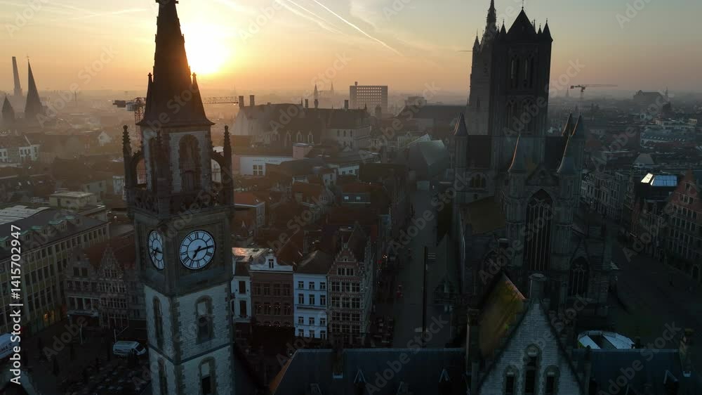 orbiting shot of Ghent old town aerial view at sunrise, tourist destination in Belgium, drone shot of Belgian medieval town of Ghent with gothic cathedrals in the morning