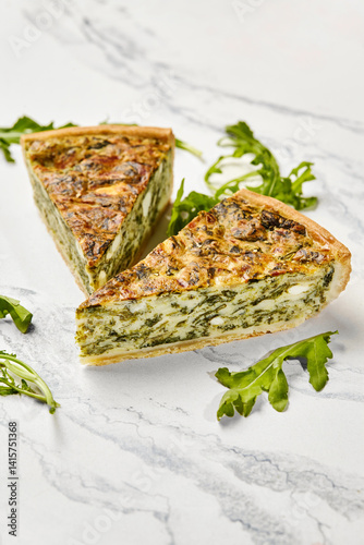 Obraz na płótnie Delicious spinach and feta quiche slices with fresh arugula on marble w salonie