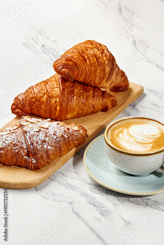 Obraz na płótnie Delicious french croissants and cappuccino resting on marble table w salonie