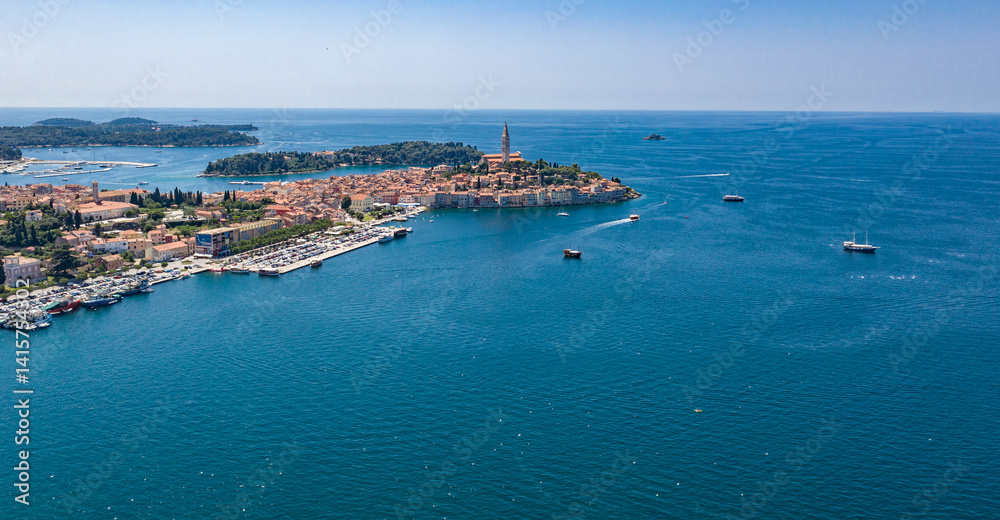 Fototapeta premium Aerial drone view of the sea and islands. High-resolution top-down drone shot of sea, sky, islands and clear sky. Soft lighting ideal for travel, landscape or nature themes.