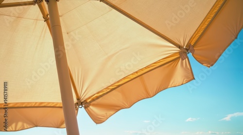 Fototapeta Naklejka Na Ścianę i Meble -  Sunlight catching stitching on beach umbrella fabric