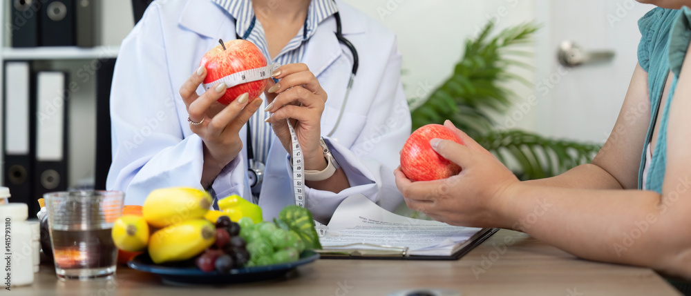 Nutrition and Measurements. A nutritionist measures an apple while discussing health with a patient. Nutrition and Measurements. A nutritionist measures an apple while discussing health with a patient.