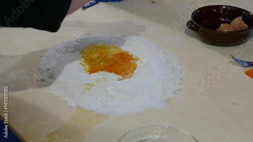 Chef grating garlic into raw egg in flower for food preparation photo