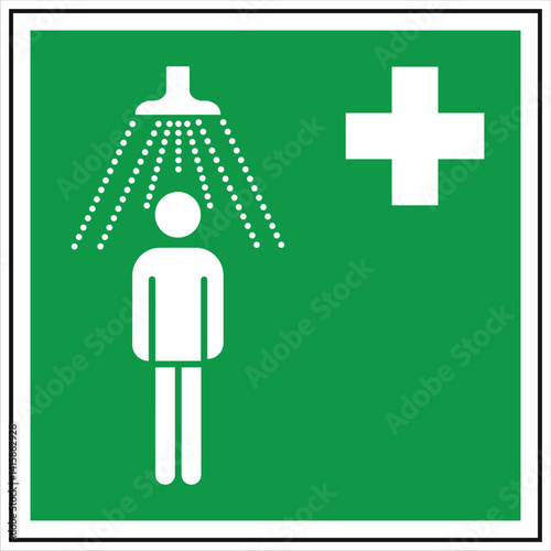 Green and white first aid sign indicating the location of an emergency shower