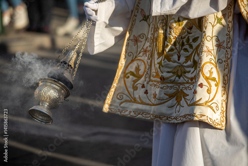 Altar boy in Holy Thursday procession attire carrying an incense burner in the city of Murcia, Spain