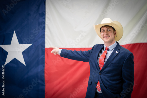 Obraz na plátně Smiling Texas Businessman Politician Wearing Cowboy Hat and Suit Pointing At Lar