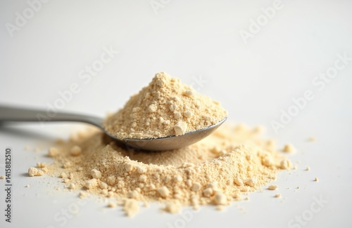 Lecithin powder heap with spoon on white background. Isolated, pure, raw ingredient, essential nutrient. Sunflower lecithin powder. Healthy food, nutritional supplement for liver health. Diet,