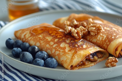 Delicious Pancakes Filled With Nuts and Blueberries on a White Plate With Syrup