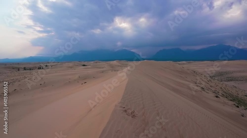 Scenic desert landscape with sand dunes and distant mountains