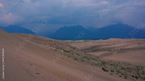 Scenic desert landscape with sand dunes and distant mountains