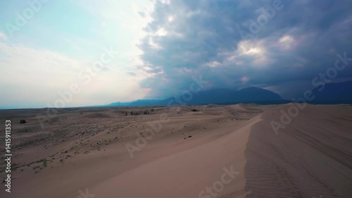 Scenic desert landscape with sand dunes and distant mountains
