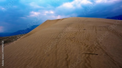 Scenic desert landscape with sand dunes and distant mountains