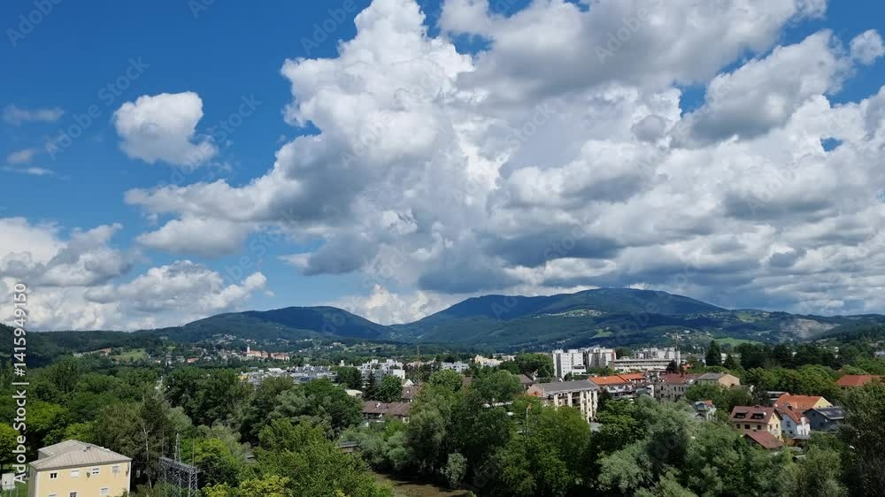 Timelapse of Cumulus clouds forming in the blue sky above the city of Graz, Austria. White giant fluffy clouds moving in summer day, 4K Timelapse of Cumulus clouds forming in the blue sky above the city of Graz, Austria. White giant fluffy clouds moving in summer day, 4K