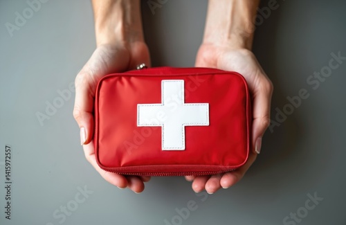 Woman holds red first aid kit bag with white cross. Medical emergency help equipment for treatment, health care. Healthcare concept. Disaster, urgent care and accident aid.
