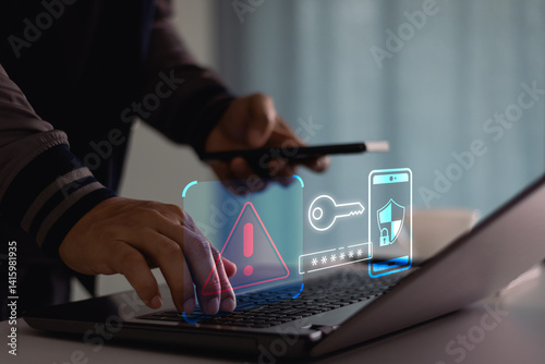 Cyber crime and cyber security alert warning concept. Hand using laptop and smartphone with 2 step verification for identity identification, multi factor authentication, information secure encryption.