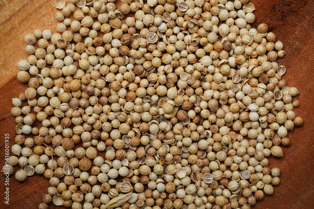 coriander seeds in a wooden bowl coriander seeds in a wooden bowl