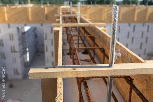Close-up of Construction Site: Detailed View of Rebar and Wooden Formwork for Concrete Foundation