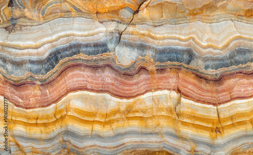 close-up of stratified rock layers with varied colors and intricate patterns