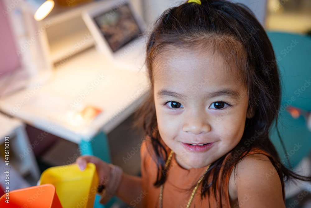 Adorable kids girl enjoy toy in kid room cozy house