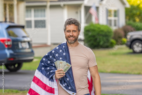 Patriotic man. Man with American flag and dollar money. Inflation concept. American tax policy. Hispanic man and USA flag. Paying tax in America. Value added tax. Taxation and tariff system