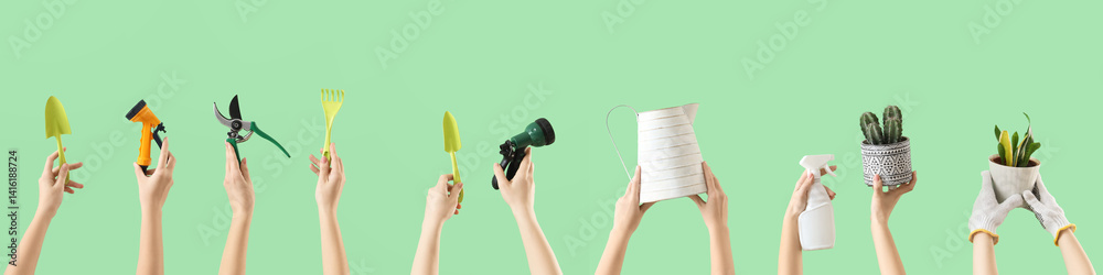 Female hands with gardening tools on green background